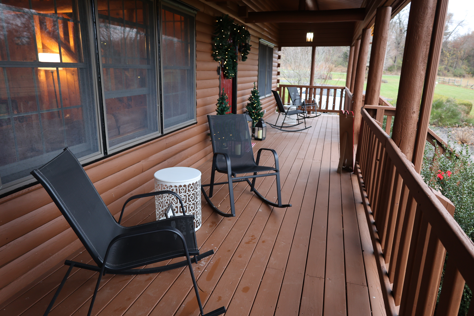 Farmhouse wraparound porch with rocking chairs